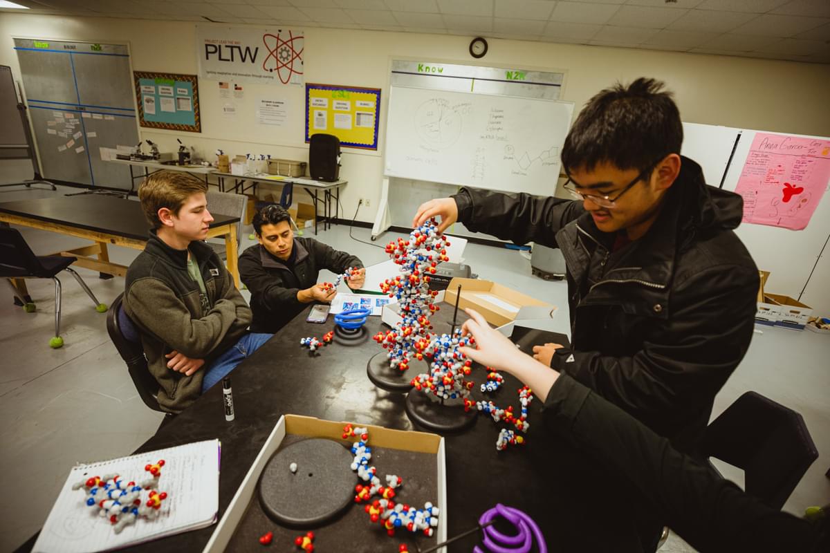 Students working on a helix